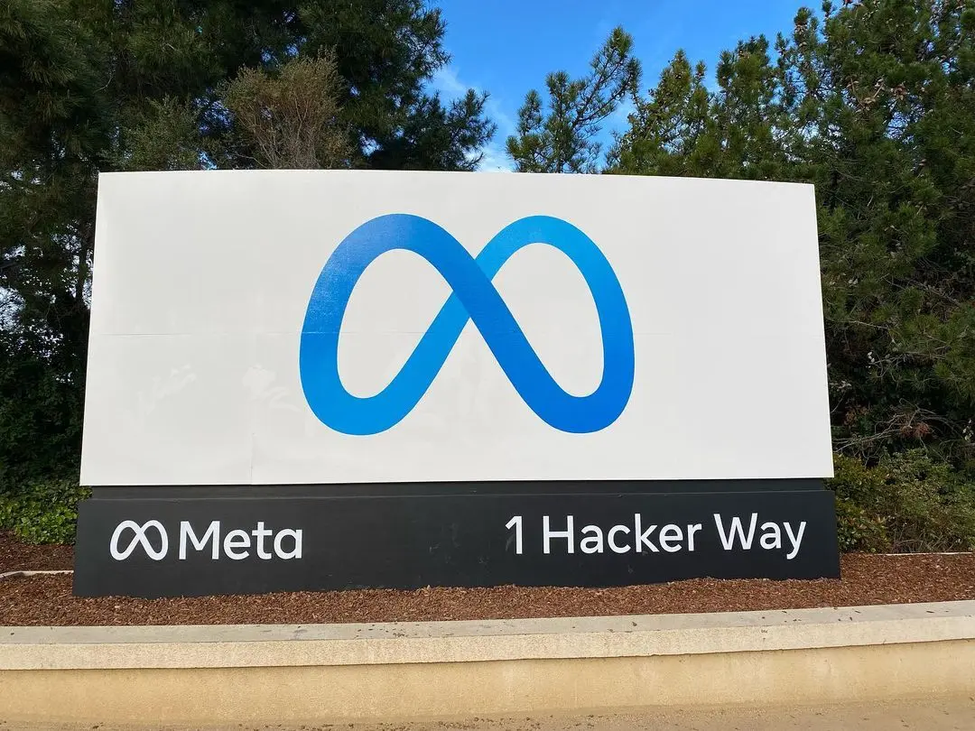Het Meta-logo en de tekst '1 Hacker Way' op een bord bij het hoofdkantoor.